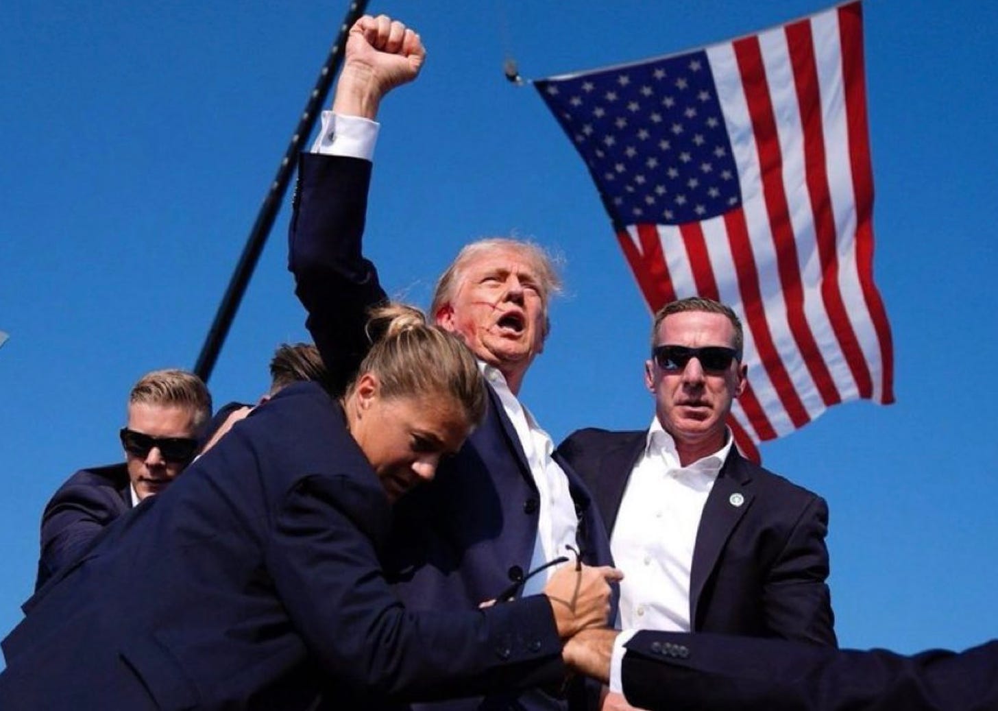 President Trump fist pumping the crowd after being shot in the head