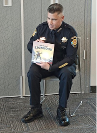 Police Officer reading a BRAVE Book